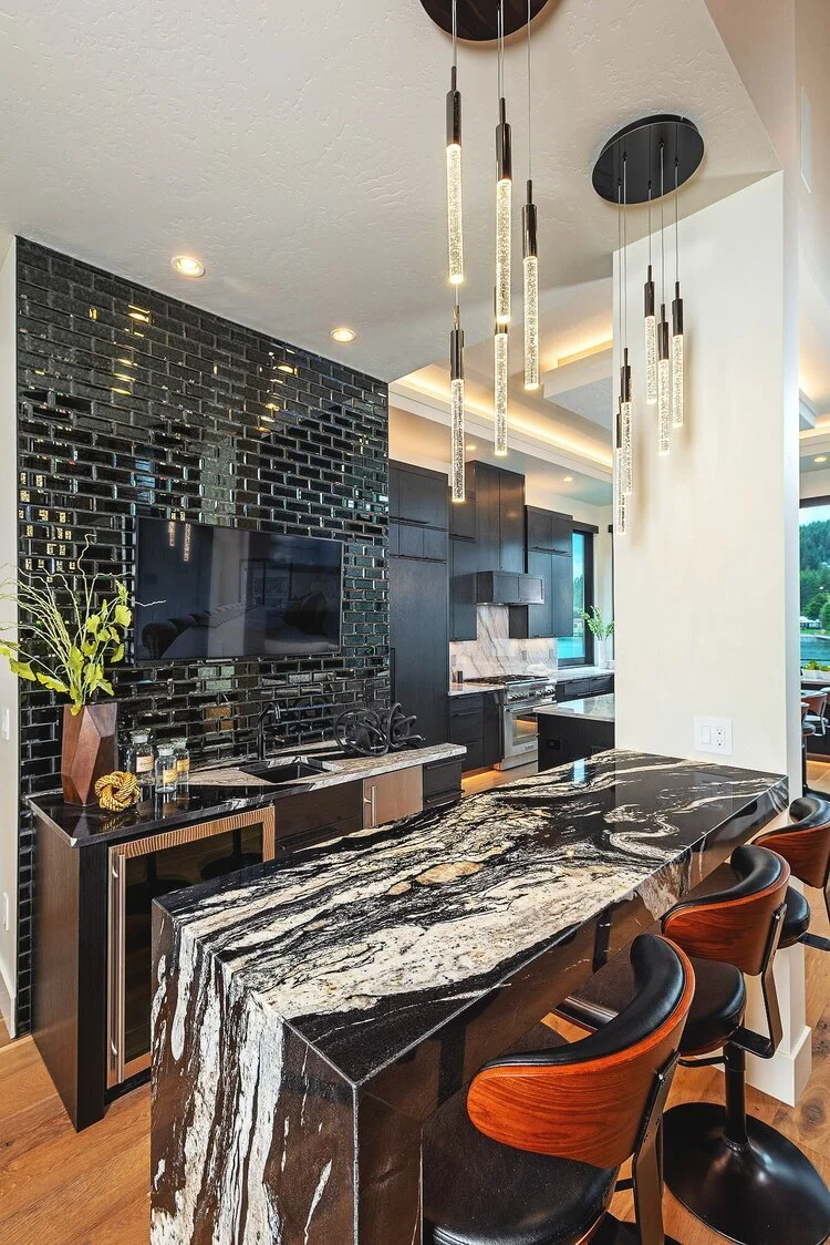 luxury bar with marble counter and intricate finishes in custom modern home