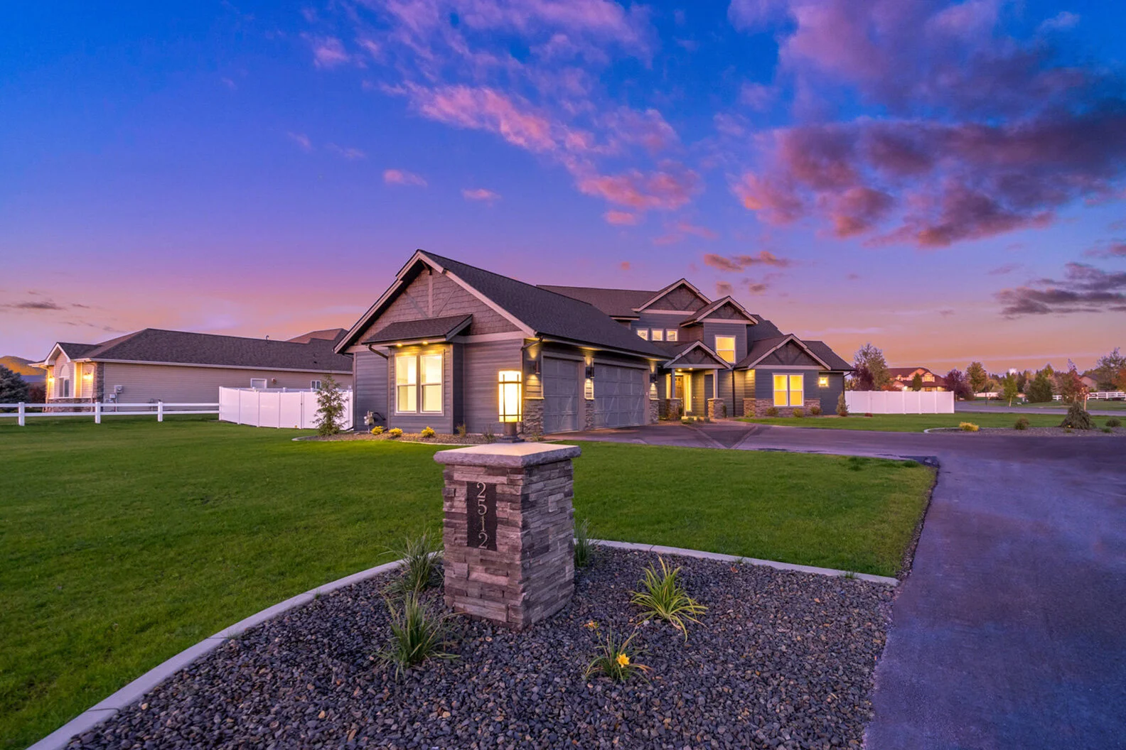 exterior evening view of illuminated luxurious custom modern home