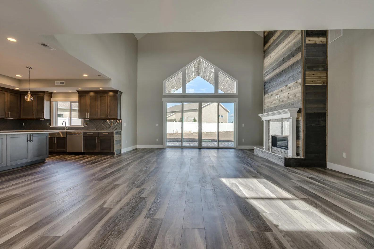kitchen counter and great room with fireplace in custom modern luxury home