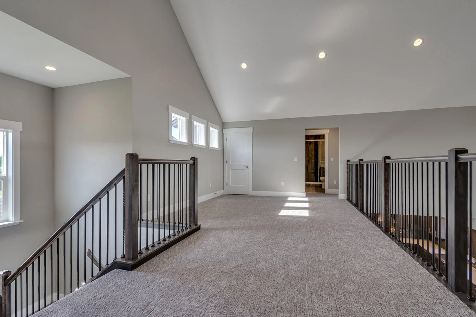 stairs leading to mezzanine level in luxurious custom modern home