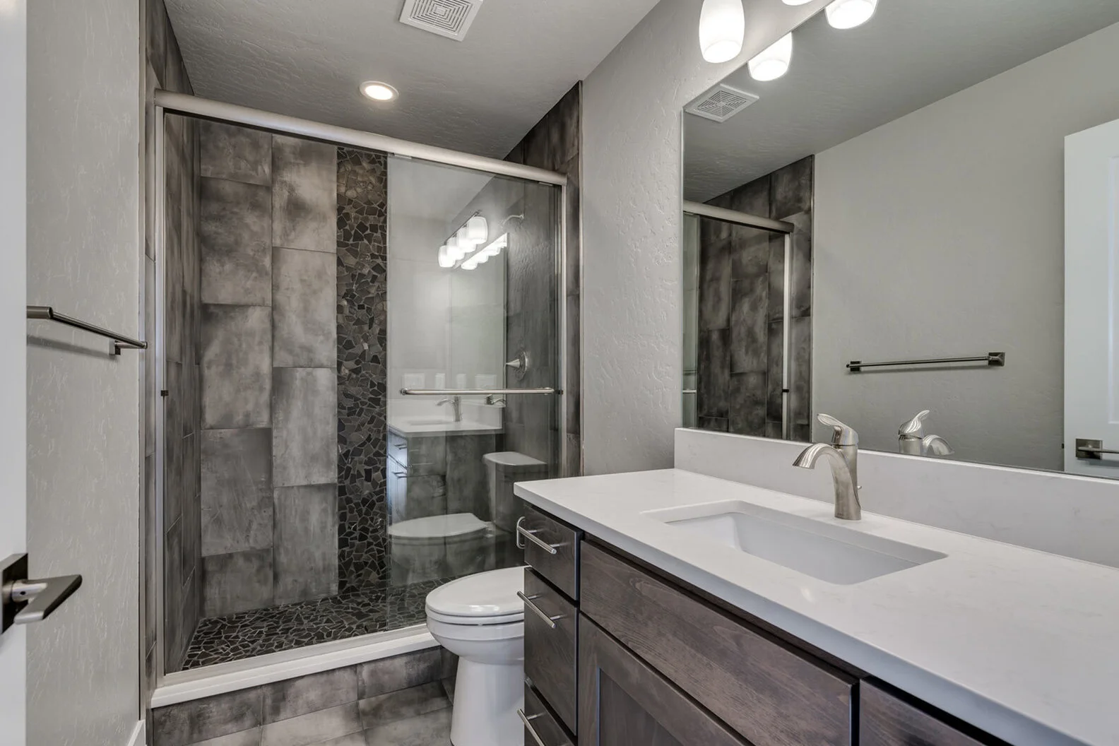 bathroom with large walk-in shower in luxurious custom modern home