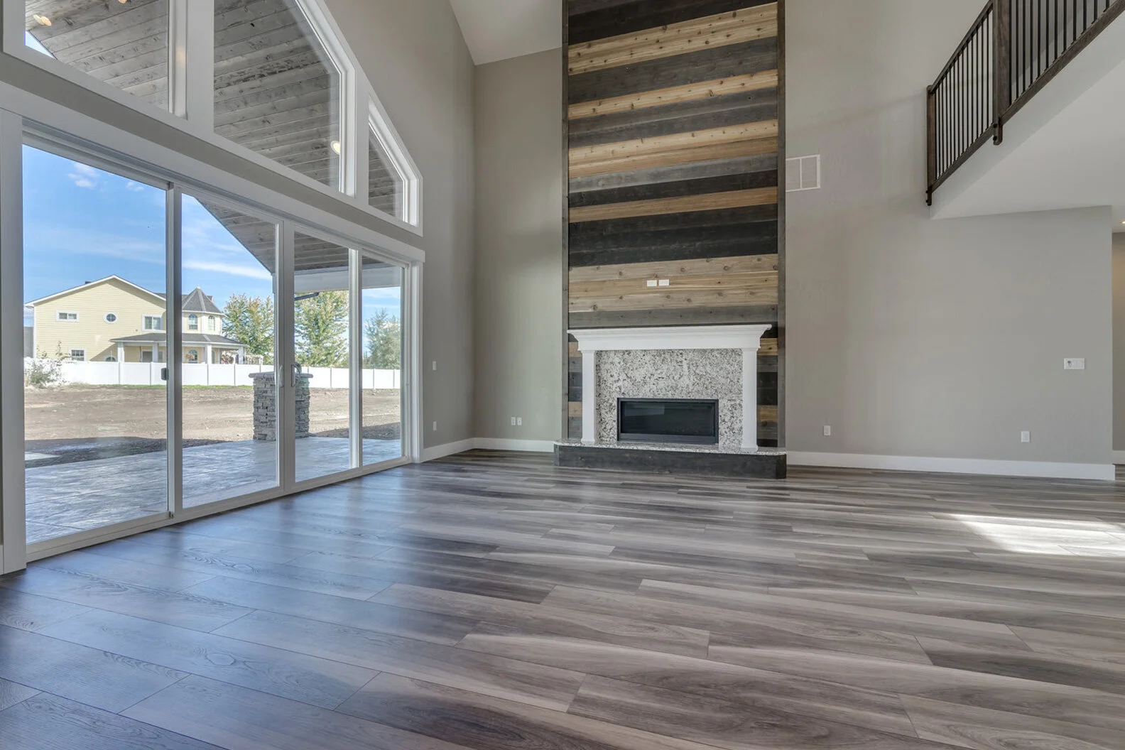 great room with large windows in luxurious custom modern home
